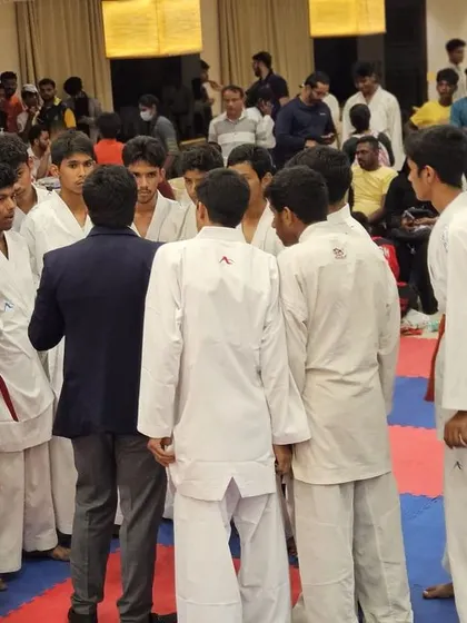 A pre-match huddle. I give last minute instructions and motivation to a group of our fighters before they step onto the mat.