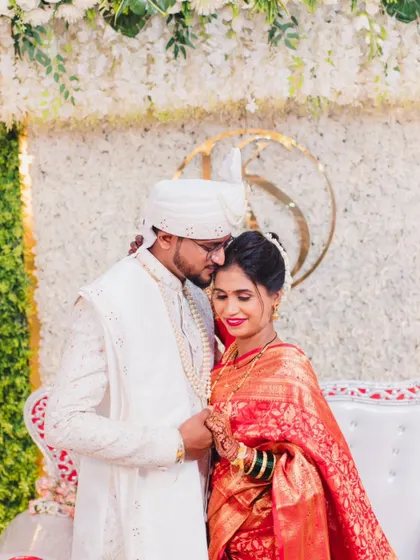 A romantic moment between the newlyweds, sharing a quiet embrace after their ceremony.