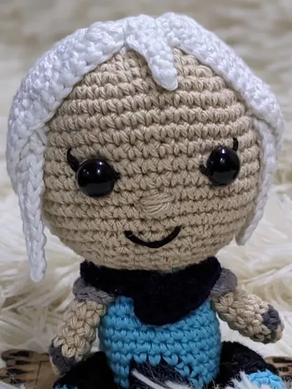 A close-up portrait of the handmade Jett doll.