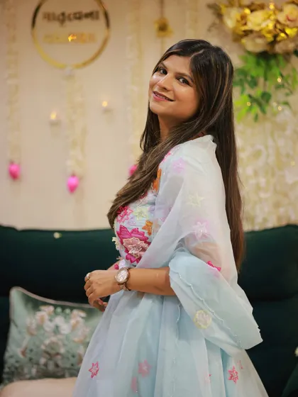 A closer look at the soft blue pastel lehenga, highlighting the intricate floral embroidery on the blouse and the organza dupatta.