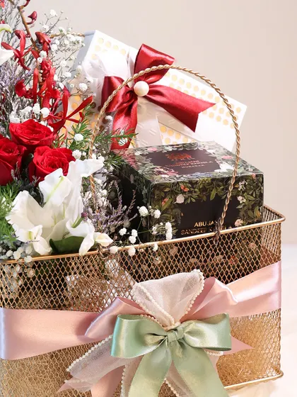 A closer look at the gifts inside the Mother's Day basket, including a box of premium Abu Jani Sandeep Khosla treats.