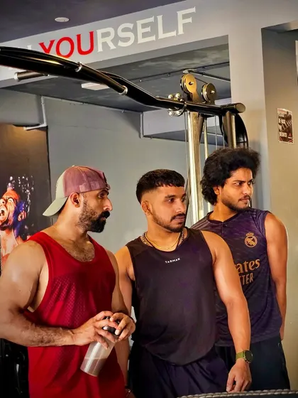 We are a team, unstoppable together. Here I am with two of my clients at Throne Fit, discussing our next set. The community and camaraderie we build are just as important as the weights we lift.