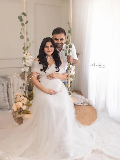 An intimate moment between expecting parents, captured on our dreamy swing set. The soft lighting and romantic styling create a beautiful memory of this special time.
