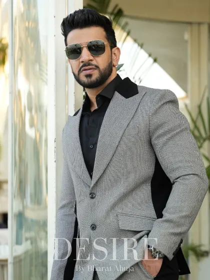 A closer look at the grey and black blazer, highlighting the textured fabric and the sharp contrast of the color-blocking.