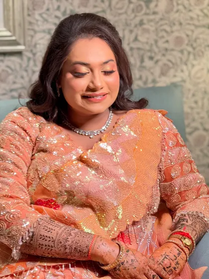A soft, peachy glam look for a sangeet, with shimmery eyeshadow and a glowing complexion.
