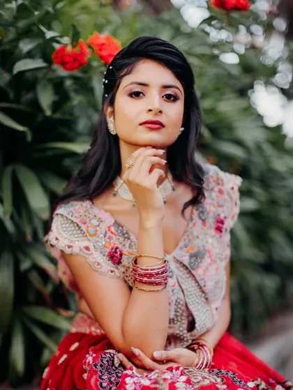 A stunning portrait of Rishika. The makeup features a bold red lip that ties the whole look together.