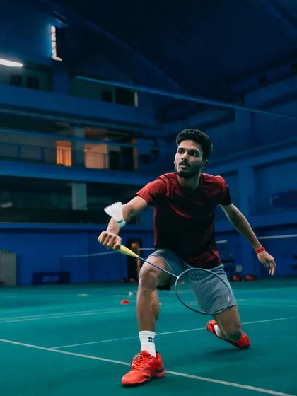 Ready for the return. This image captures the intense focus of a player during a fast-paced rally, showcasing the agility required in badminton.