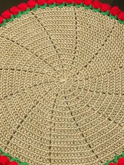 A beige doily with a red tulip border, a warm and inviting combination.