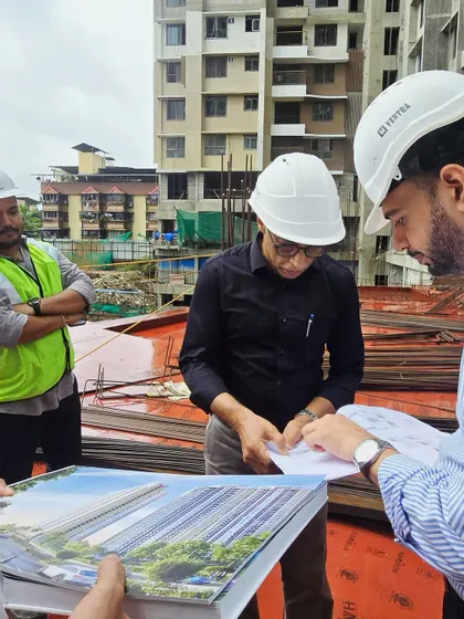 Here I am on site with my team, reviewing plans for a large residential project in Mumbai. This collaborative, on-the-ground approach is essential for managing complex projects and ensuring every detail is executed correctly.