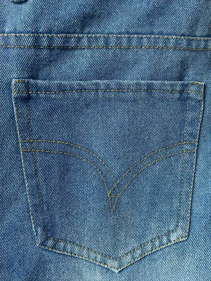 The signature arcuate stitching on the back pocket of a custom-made pair of jeans, a timeless detail that I can replicate for an authentic look.
