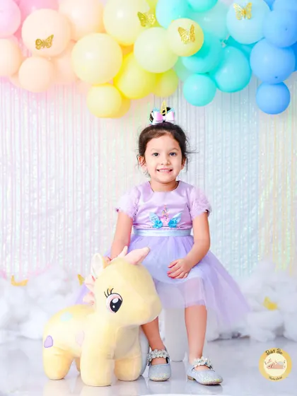 In our Unicorn Dreams theme, we use pastel rainbow colors, fluffy clouds, and of course, a friendly unicorn. This setup is perfect for capturing the magic of childhood for your little dreamer.