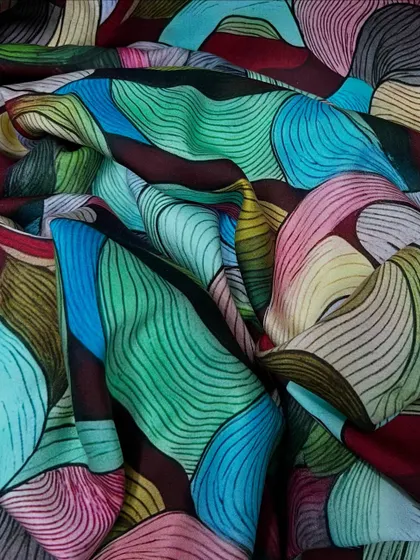 This rayon satin with its abstract, colorful print is a piece of wearable art. Its smooth drape makes it perfect for creating flowing dresses and sarees.