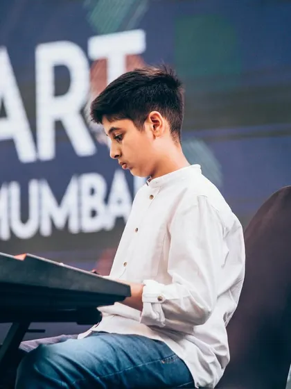 One of our keyboard students, deep in concentration during his performance at Art Mumbai. Our keyboard lessons cover everything from classical pieces to modern pop songs.