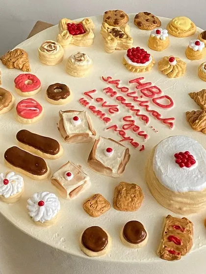 A cake for the ultimate foodie, decorated with dozens of miniature edible pastries, from croissants and donuts to eclairs.