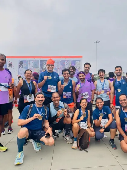 A proud moment for our runners in their club jerseys, displaying their finisher medals after a challenging 10k race.