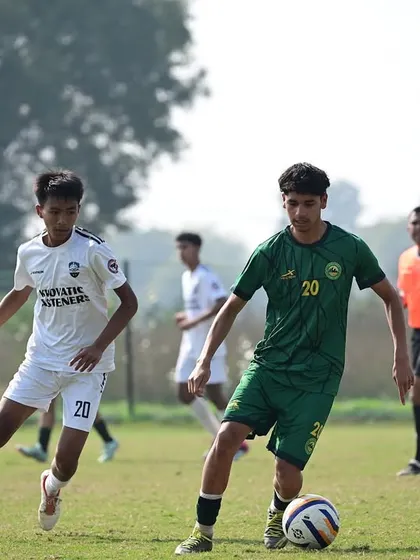 A player dribbling past an opponent in the Dream Sports Championship. Our training focuses on developing individual skill and confidence on the ball.