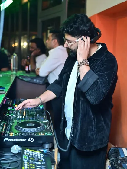 Listening closely to the cue in my headphones at Tipsy Bull. Precision is key to a seamless mix.