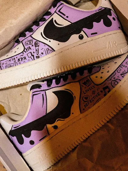 Another look at the "Lavender Haze" inspired sneakers, showing the doodle details and the dripping paint effect that wraps around the heel.