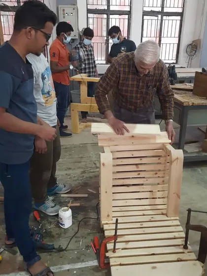 Our chief trainer guides students through the assembly of a slatted chair, offering advice on alignment and clamping techniques.