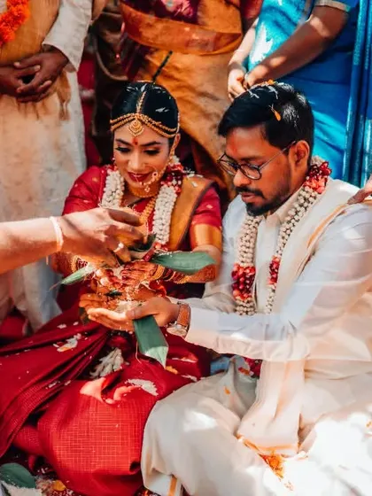 A close-up of a sacred ritual during a South Indian wedding ceremony, capturing the details of the tradition.