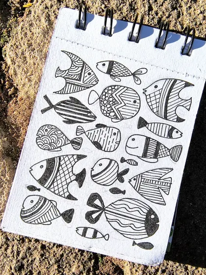A simple pen-and-ink doodle of fish with various patterns in my sketchbook. This kind of detailed line work often inspires designs for my bookmarks and journals.