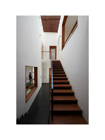 A view of the minimalist wooden staircase in the Vikas Residence.