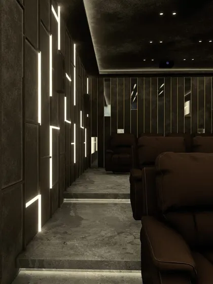 The view down the aisle of this modern theater, showcasing the dramatic effect of the custom wall lighting.