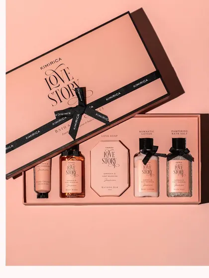 A top-down shot of a luxurious 'Love Story' bath and body gift set. The elegant packaging and neat arrangement convey a sense of premium quality and make it an ideal gift.