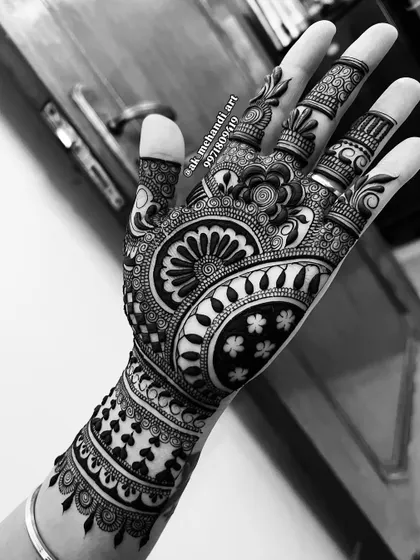 A black and white photo that highlights the contrast and intricate details of a full bridal design.