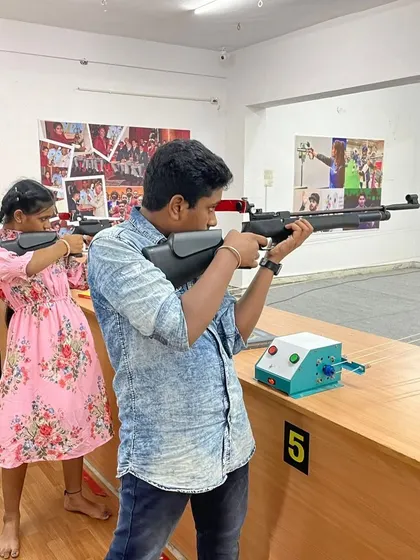 Two young shooters practice side-by-side at the range, learning together in a supportive environment. My sessions are great for siblings and friends.