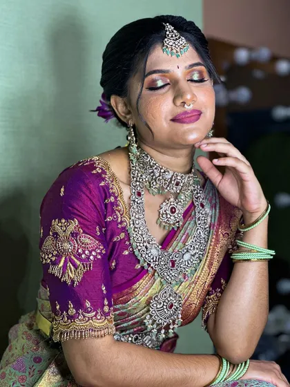 A close-up shot capturing the beautiful eye makeup and the intricate details of the jewelry.