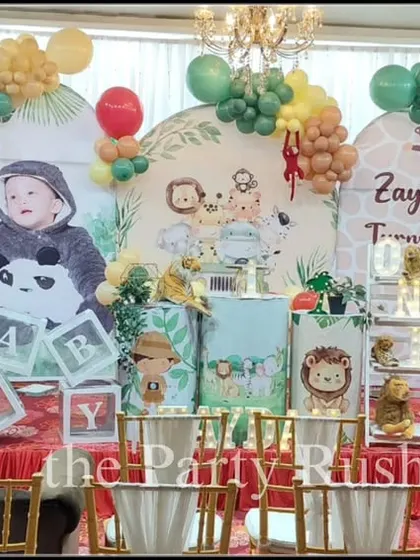 Zaydan's first birthday was a cute and colorful jungle party. The decor features adorable cartoon animal cutouts, a personalized backdrop, and a multi-colored balloon garland, perfect for a cheerful and bright celebration.