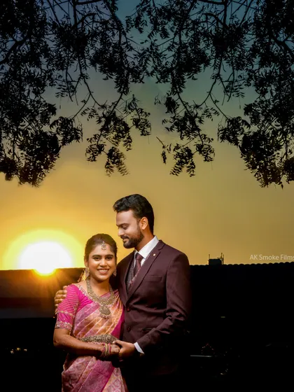 A sunset portrait with a creative twist, using the reflection of the tree branches to frame the couple.