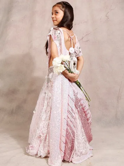 A beautiful shot of our pink ombre lehenga, highlighting the back detail and fabric.