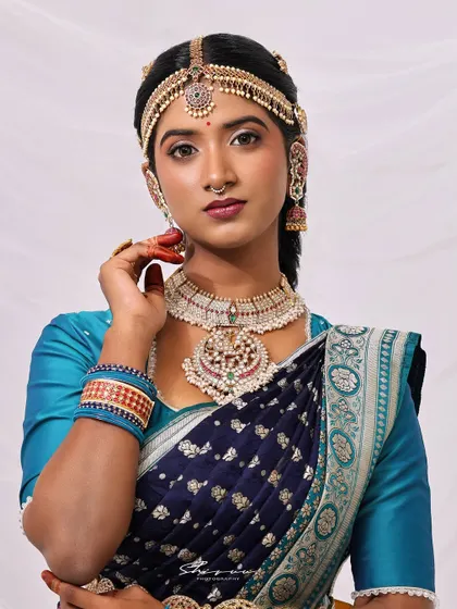 A close-up portrait that captures the essence of the look. The makeup is flawless, the jewelry is exquisite, and the expression is one of quiet confidence and grace.