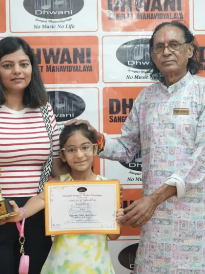 A student with her mother and guru, celebrating her achievement.