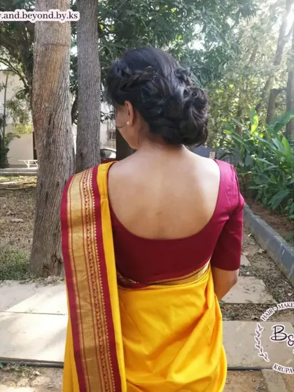 This messy updo, seen from the back, shows how a simple crown braid can add a beautiful detail to the hairstyle. It’s a classic and trendy look that I styled for a client attending her friend's wedding.