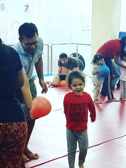 This image captures the pure excitement of a birthday party. A child runs with a bright smile, fully immersed in the fun and games of the day.