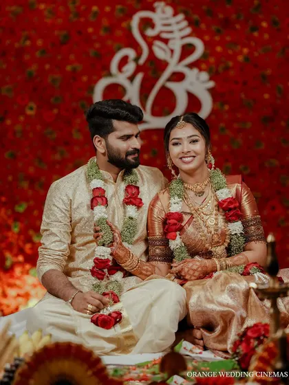 A sweet portrait of the couple seated on the mandap, sharing a happy moment.