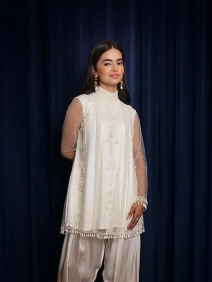 A classic, front-facing portrait in a beautifully detailed white kurta set. This is a perfect, clean shot for an e-commerce catalogue or brand lookbook.