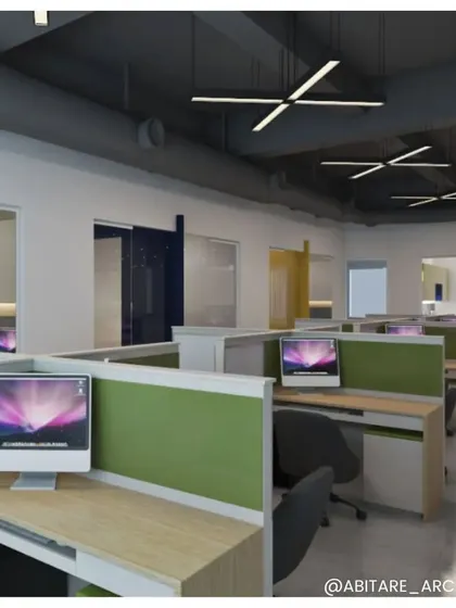 A view of the open-plan workspace at an office in Neemrana. We used low-height green partitions to define individual desks while maintaining a sense of connection and openness across the floor.