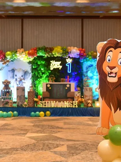 A wide shot of the jungle safari stage, showing the placement of large animal props like the lion cutout.