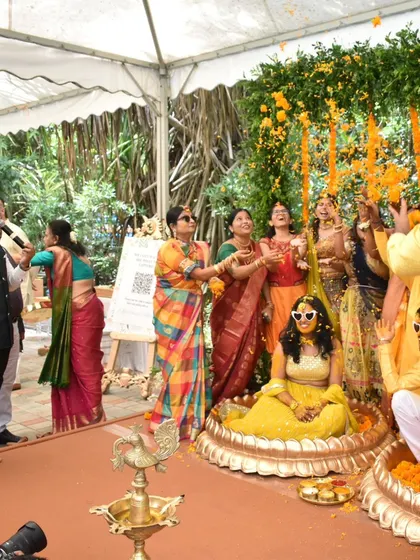 A wide shot of the flower shower during a Haldi ceremony. I get all the guests involved to shower the couple with blessings and petals.