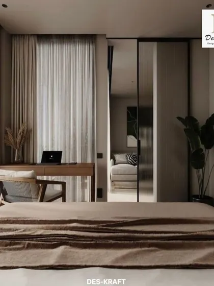This wide shot shows the bedroom's layout, with a sliding glass door that separates the sleeping area from the living space, offering both privacy and an open feel.