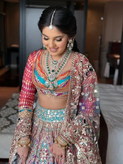 A happy and radiant portrait of the bride, ready for a night of dancing.