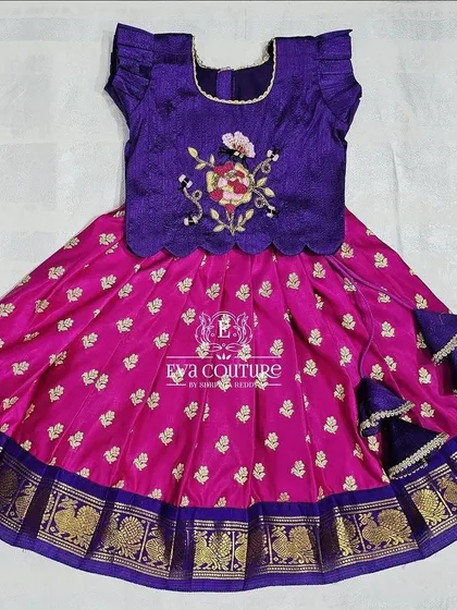 This newborn pattu pavadai is ready to dispatch. The combination of purple and pink with a traditional gold border is a timeless choice for little ones.