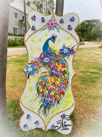 The full view of the peacock panel, showing its unique shape and the beautiful composition of the bird surrounded by sculpted flowers.