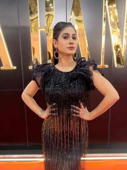 Another shot of this chic red carpet look. The hairstyle is sleek and modern.