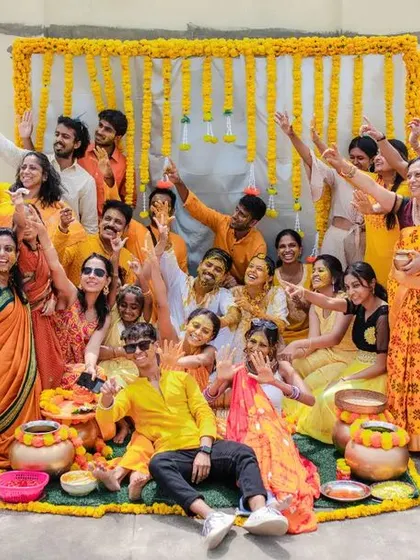 A duplicate of 8, showing the entire family and friend group celebrating at the Haldi ceremony.