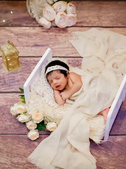 An angel at rest. This overhead shot uses a simple wooden floor, a white crate, and soft, flowing fabrics to create a beautiful, minimalist portrait.